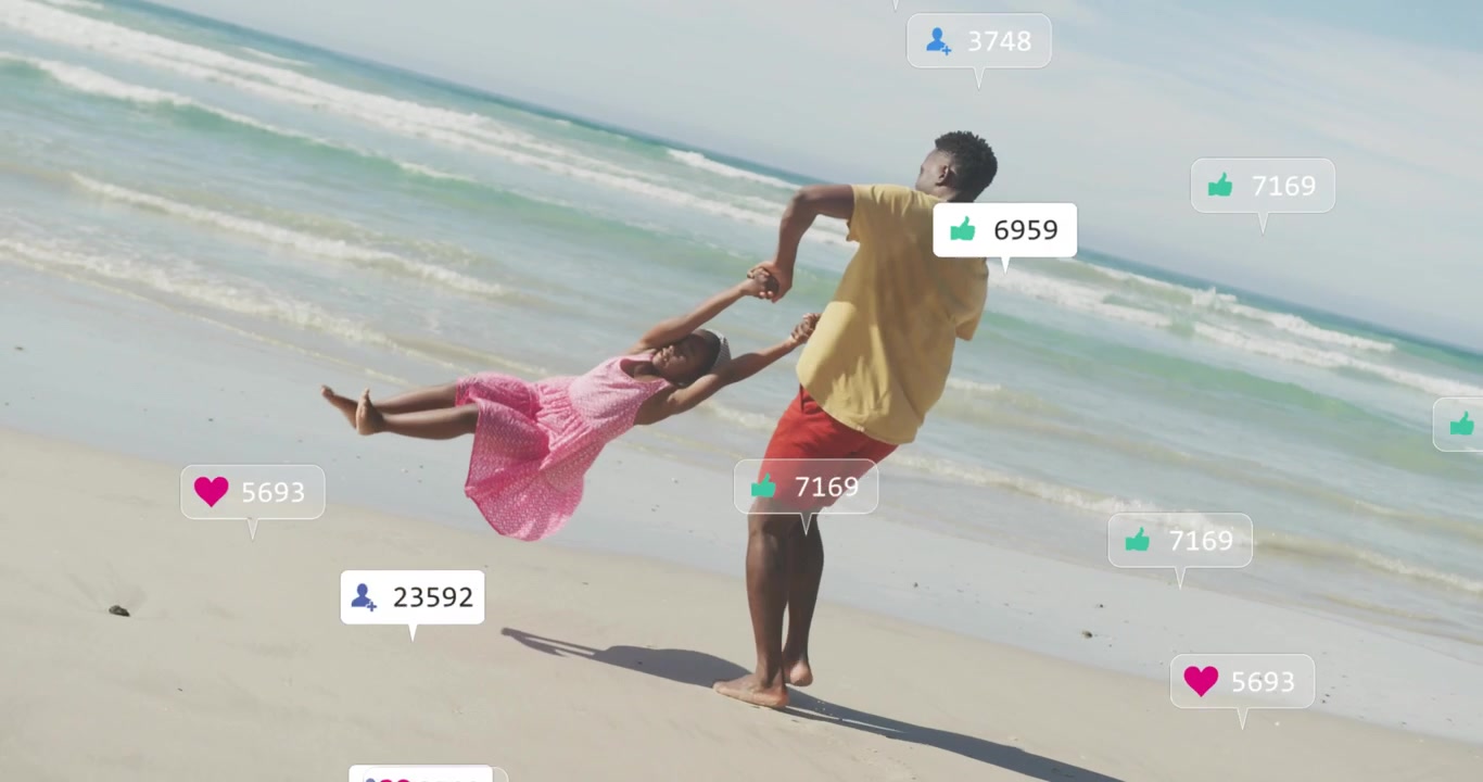 Dad holding hands swinging daughter on wet sand rotating playing, bonding while media icons rising