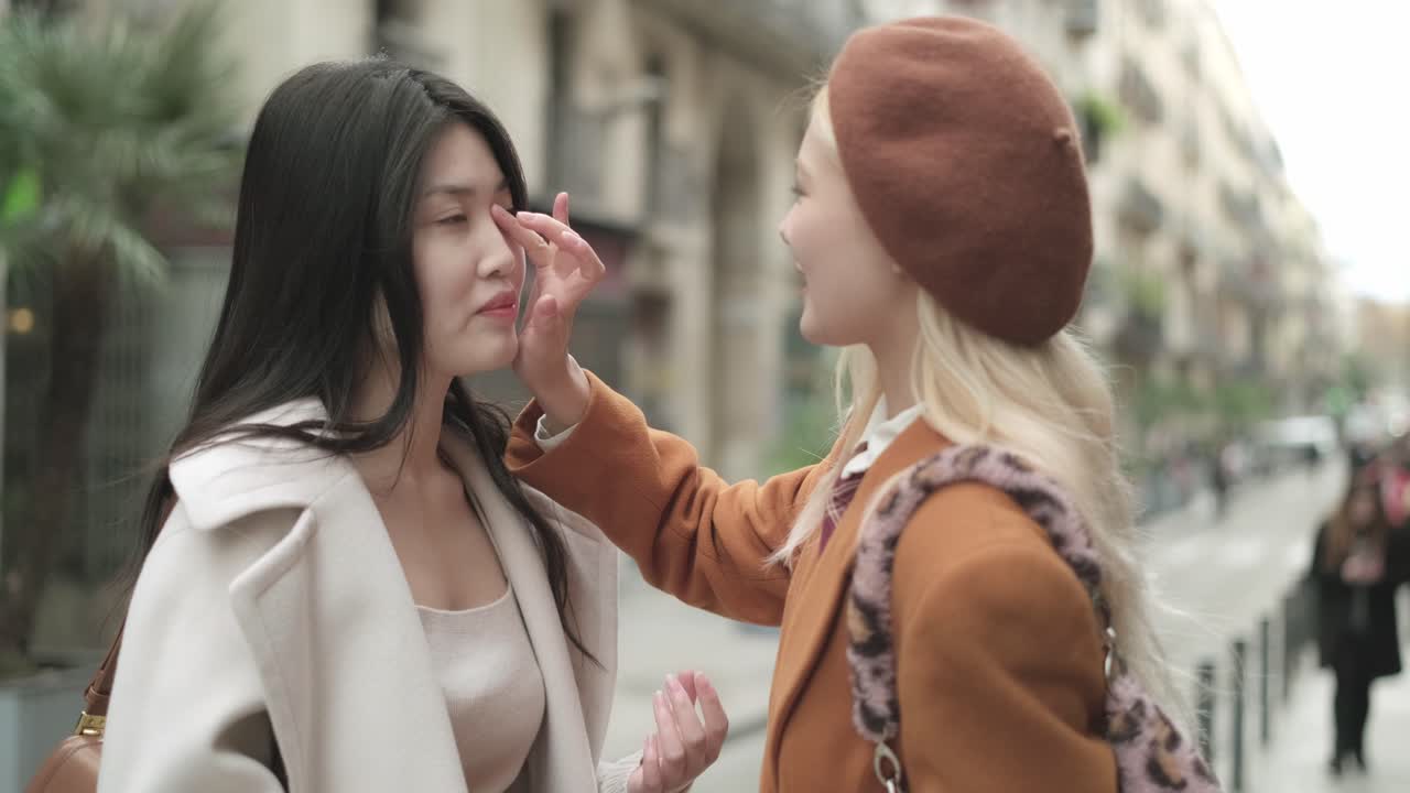 Two women in stylish outfits on a city street
