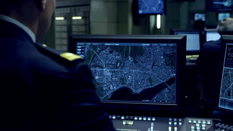 man in uniform working in a high-tech command center