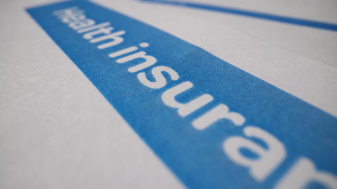 Close-up of 'Health Insurance' text on a blue stripe