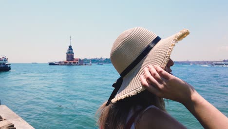 slow motion:beautiful girl enjoys bosphorus and maidens tower,a popular destination in istanbul,turkey