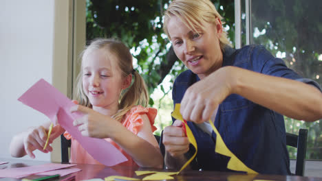 Side-view-of-Caucasian-woman-playing-with-her-daughter-at-home