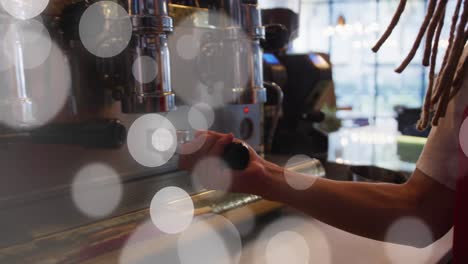 Animation-of-spots-of-light-over-man-making-coffee-working-in-cafe