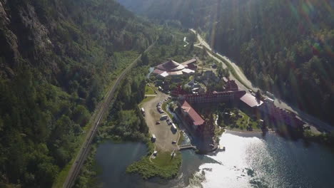 Mountain-aerial-view-of-Three-Valley-Lake-Chateau-resort,-lens-flare