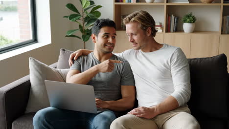 Couple Using Laptop on Couch in Living Room