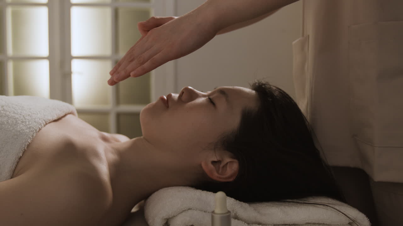 Woman receiving energy healing or a relaxing spa treatment