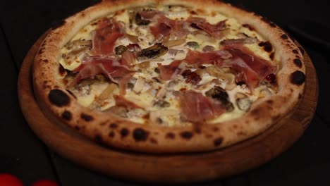 delicious gourmet pizza with prosciutto and mushrooms