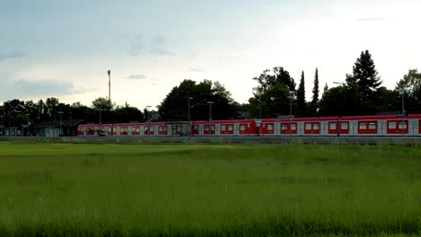 Drone-tracks-commuter-train-on-rural-stop-near-Munich