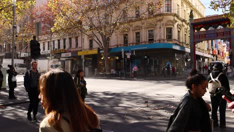 pedestrians crossing street in chinatown, melbourne