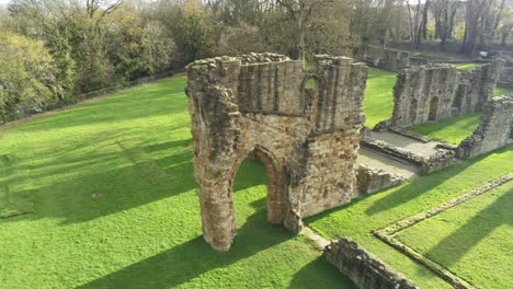 basingwerk abbey landmark medieval abandoned welsh ruins aerial view rising orbit left