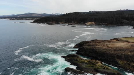 Drone-flies-over-craggy-rocks-on-the-coast