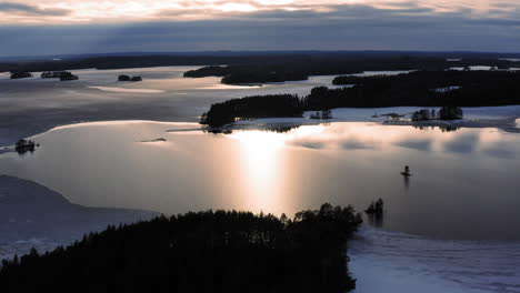 video aéreo de drones de un punto derretido en un lago congelado al atardecer