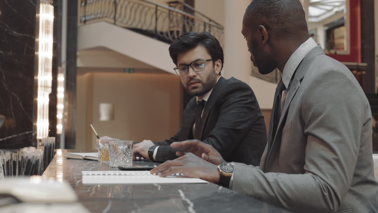 Men Working and Drinking in Bar