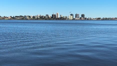 Across-the-vast-blue-water-of-the-Swan-River-to-the-South-Perth-foreshore,-Western-Australia