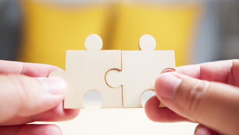 Close-Up-Hands-of-Men-Connecting-Jigsaw-Puzzle