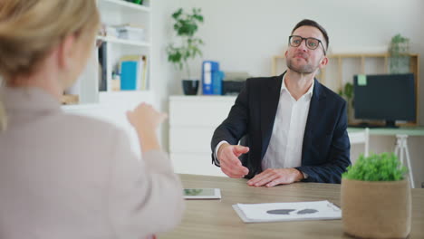 real estate agent finalizes sale, shakes hands with client