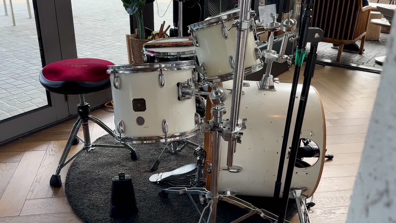 White Drum Kit Set Up in a Room
