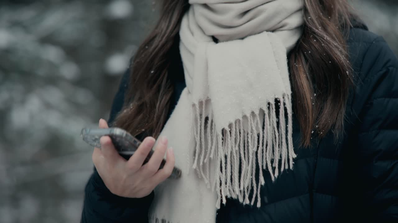 Pretty Woman With Cellphone In Winter Clothing And Warm Neck Scarf. Reveal Shot