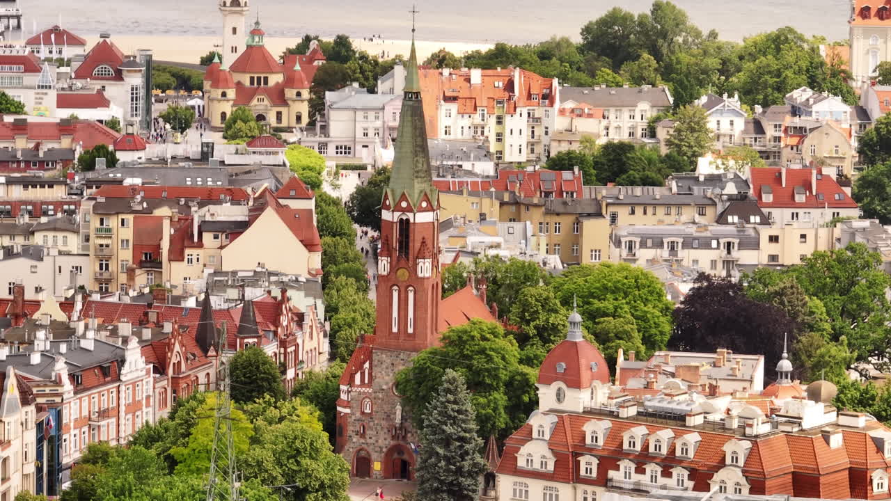 Telephoto drone shot circling the Kościół św. Jerzego w Sopocie church, in Sopot, Poland