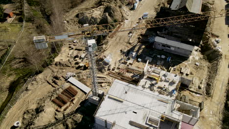 unfinished multi-storey building with tower crane during sunny day in lubawa, poland