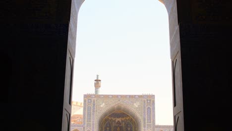 isfahan, iran - 15th may, 2022: group of tourist with guide explore courtyard friday mosque (jame mosque of isfahan)