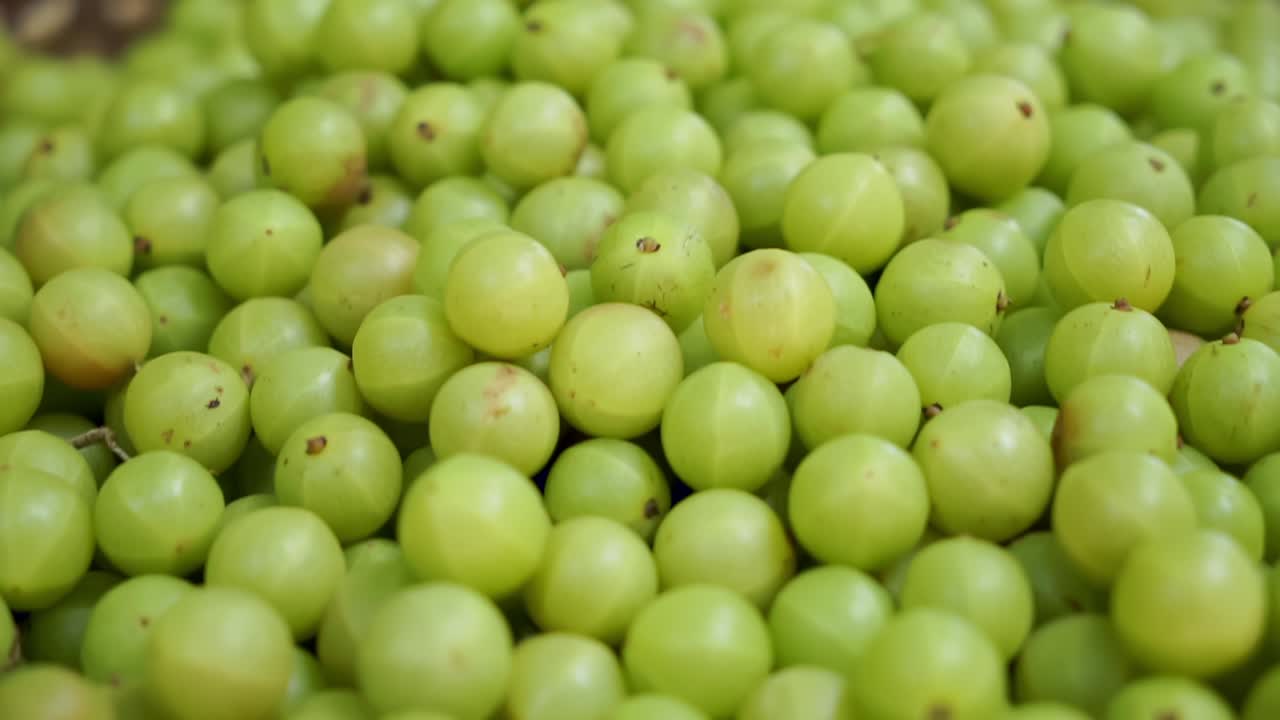 Close-up shot of Indian gooseberries in a basket at Nyaung U Market, Bagan, Myanmar