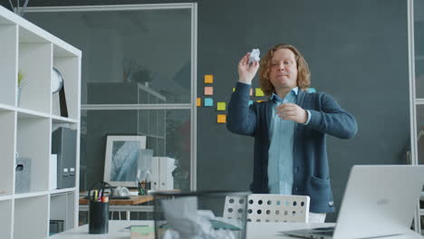 happy man dancing in modern office