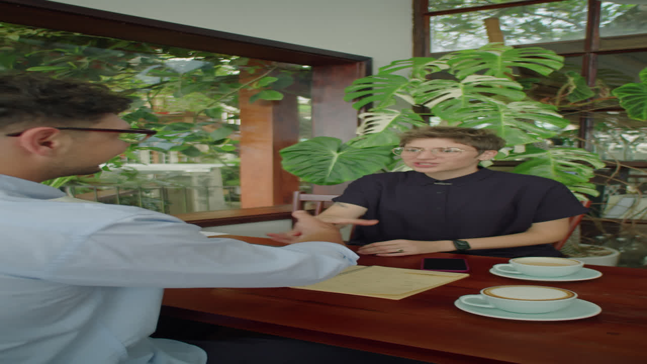 Business Partners Shaking Hands on Coffee Meeting in Outdoor Cafe
