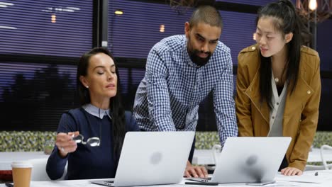 executives discussing over laptop on table 4k