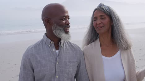 mature couple enjoying time outside by the sea