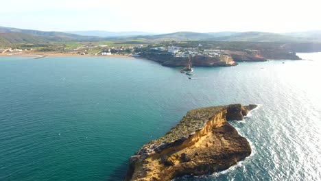 aerial shot by drone of small island with seagulls flying in groups and a beautiful cliff in ain témouchent algeria