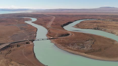 drone fly landscape of santa cruz bended river in el calafate patagonia argentina, blue sky and mountains background