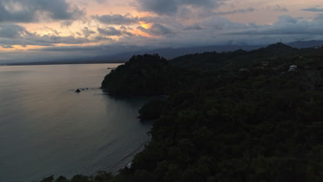 sunset aerial over jungle tree tops overlooking pacific coast costa rica, 4k