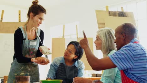 woman assisting artists in pottery 4k