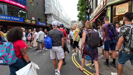 crowded street with people walking and shopping