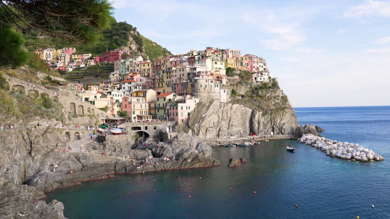 Colorful houses atop cliffs in Cinque Terre, Italy with serene sea view Manarola