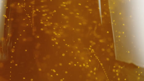 close-up of a golden beverage with bubbles