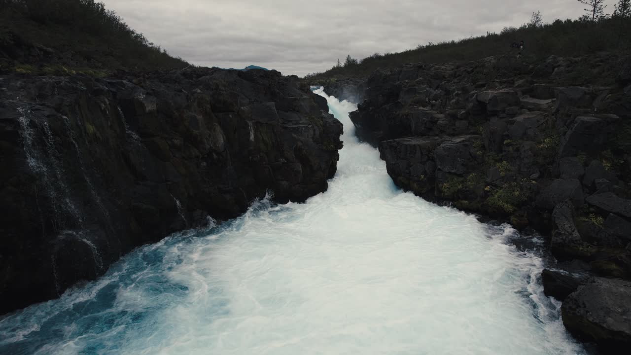 Aerial clear blue waterfall river hlauptungufoss Iceland, flying over flowing water, icelandic landscape