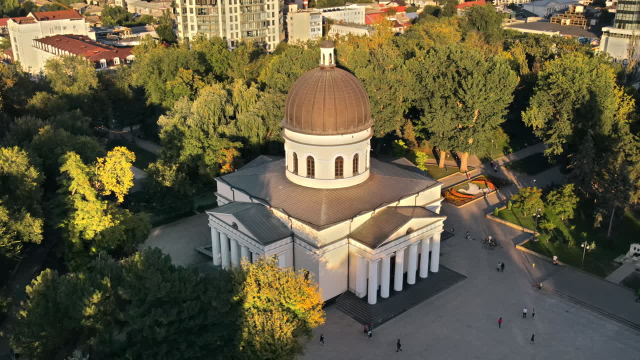 Aerial drone view of Chisinau downtown at sunset. View of central park, Cathedral, a lot of greenery, walking people. Moldova