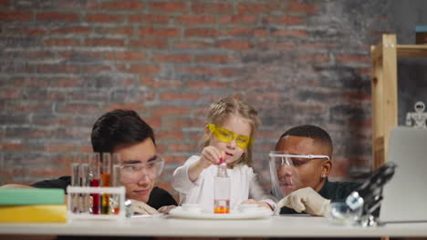 student looks at changing color paint during chemical test