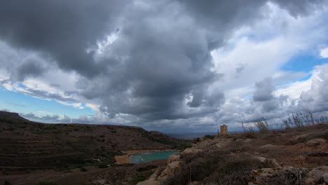 dramatic big dark clouds over the lippija tower and gnejna bay timelapse