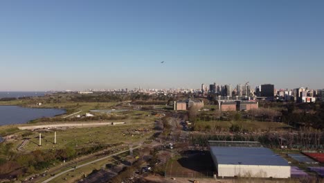 aerial flight along coastal area of buenos aires and arriving airplane at airport during sunset