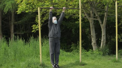 Active senior old man do stretching physical exercises in coronavirus quarantine