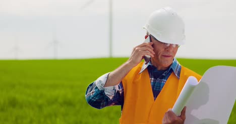 Engineer-Talking-On-Mobile-Phone-While-Walking-In-Farm-7