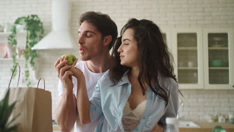 Young-married-couple-playing-with-food-at-home