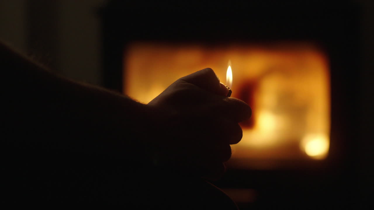 Person with lighter near a Fireplace