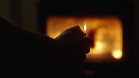 person with lighter near a fireplace
