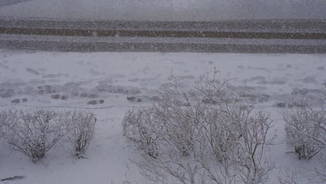 footprints on snowy sidewalk during winter blizzard snowstorm, static abstract concept shot