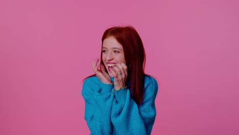 teen girl in blue sweater shouting, raising fists in gesture i did it, celebrating success, winning