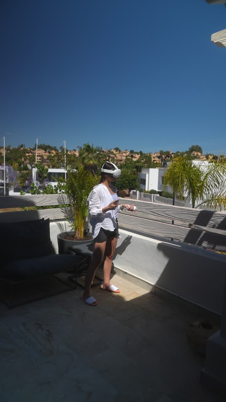 Woman using VR headset on a balcony